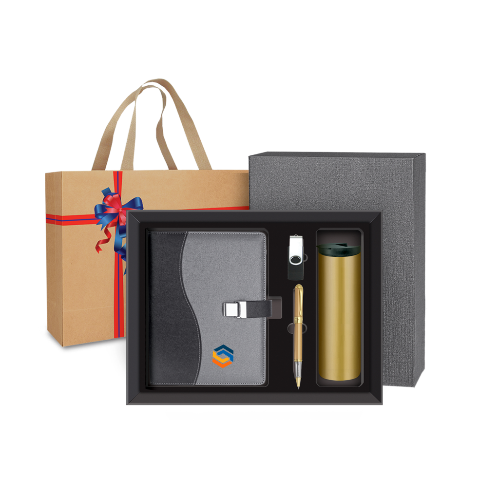 Corporate Gift set with a notebook, pen, and tumbler in a box, with a gift bag in the background.