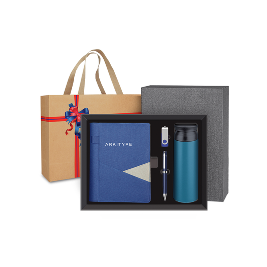 Gift set with blue notebook, pen, and thermos in a box, with a brown bag featuring a red ribbon on a white background.