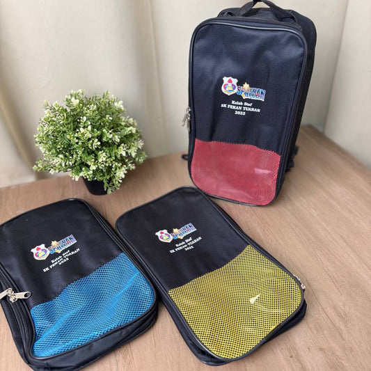 Custom Shoes Bag  Three travel bags with visible logos on a wooden surface with a plant in the background.
