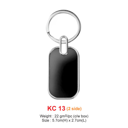 Black rectangular keychain with silver ring on a white background